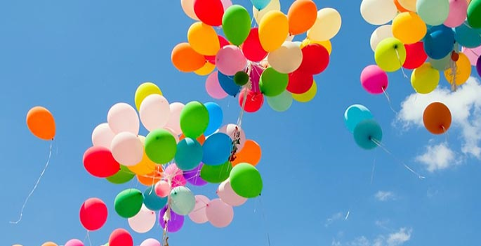 bright coloured balloons floating in the sky